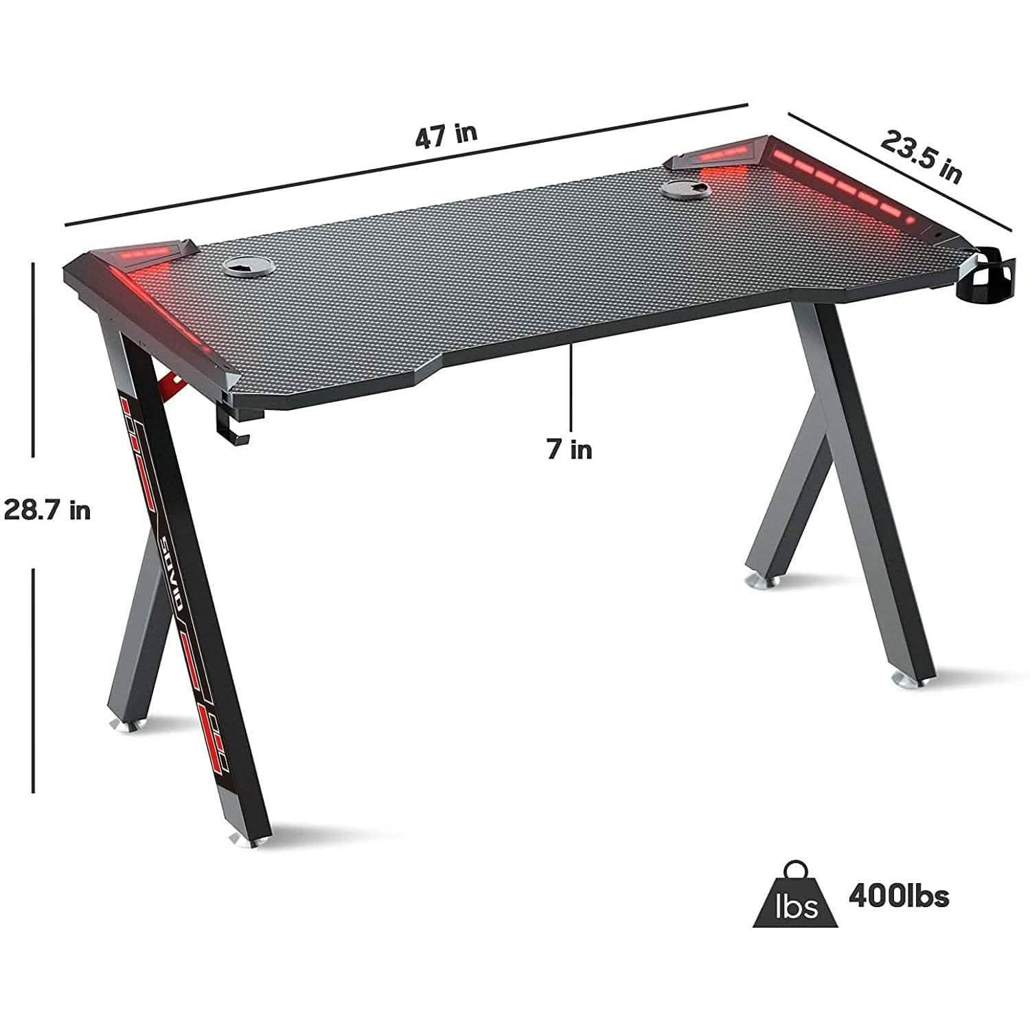 Flusha Gaming Desk with LED RGB lights, designed for video games and consoles, featuring a spacious surface and vibrant lighting.